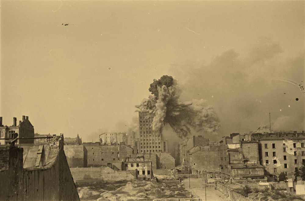 The Prudential tower struck by a shell during the 1944 Warsaw Uprising, smoke erupting beside it